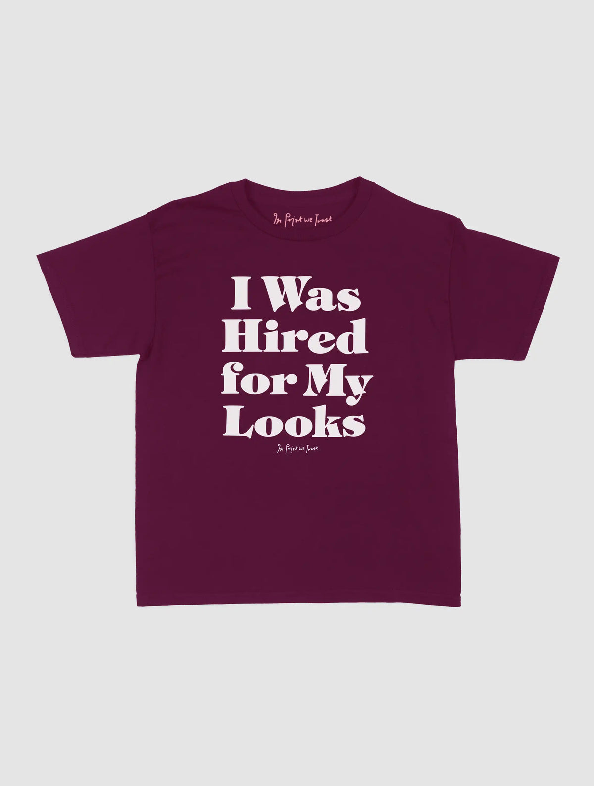 hired for my looks baby tee