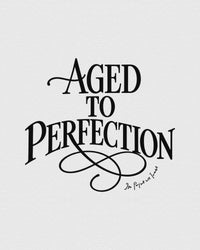 aged to perfection baby tee - In Print We Trust